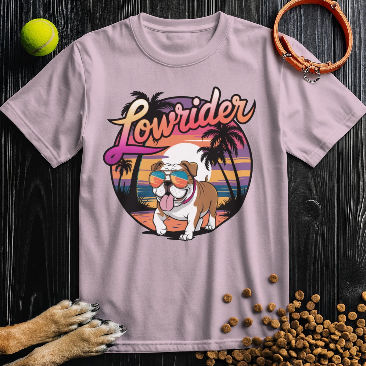 Light pink Lowrider Bulldog Sunset T-Shirt with a playful bulldog in sunglasses and sunset scene. Soft cotton tee ideal for warm weather style.