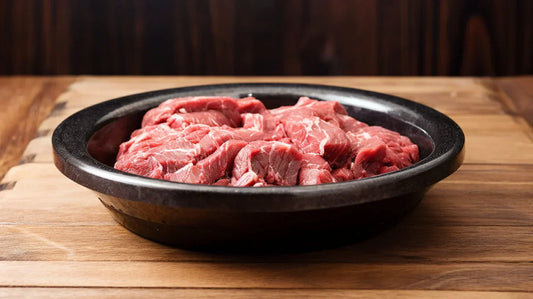 Raw steak on a plate – examining if dogs can safely eat raw meat and the risks involved.