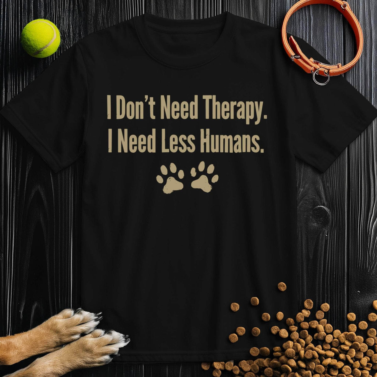Black Therapy T-Shirt - Need Less Humans with beige text and paw prints, 100% cotton, sustainable and unisex for everyday comfort.