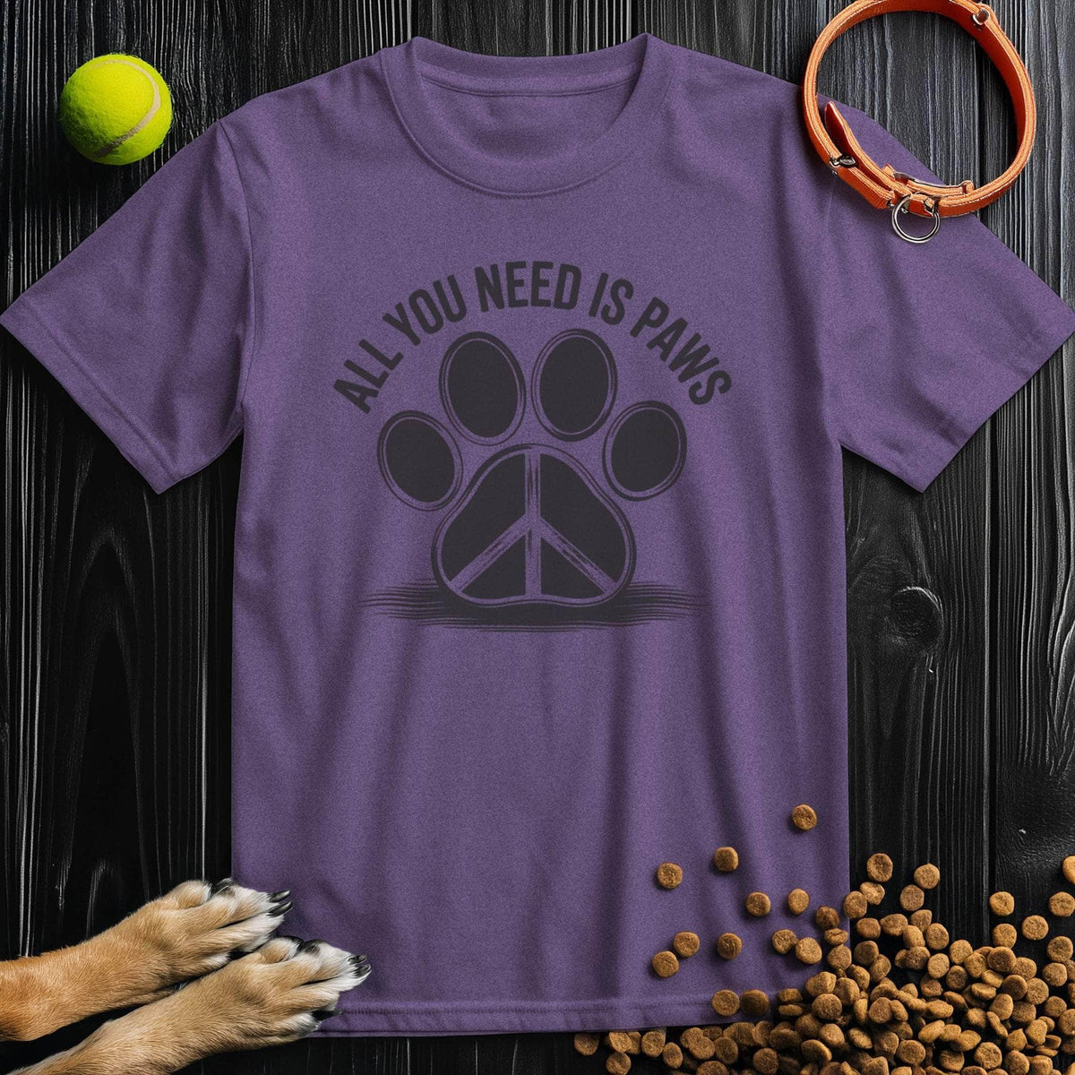 Purple All You Need Is Paws T-Shirt with black paw print and peace symbol, 100% cotton. Stylish and eco-friendly tee for dog enthusiasts.