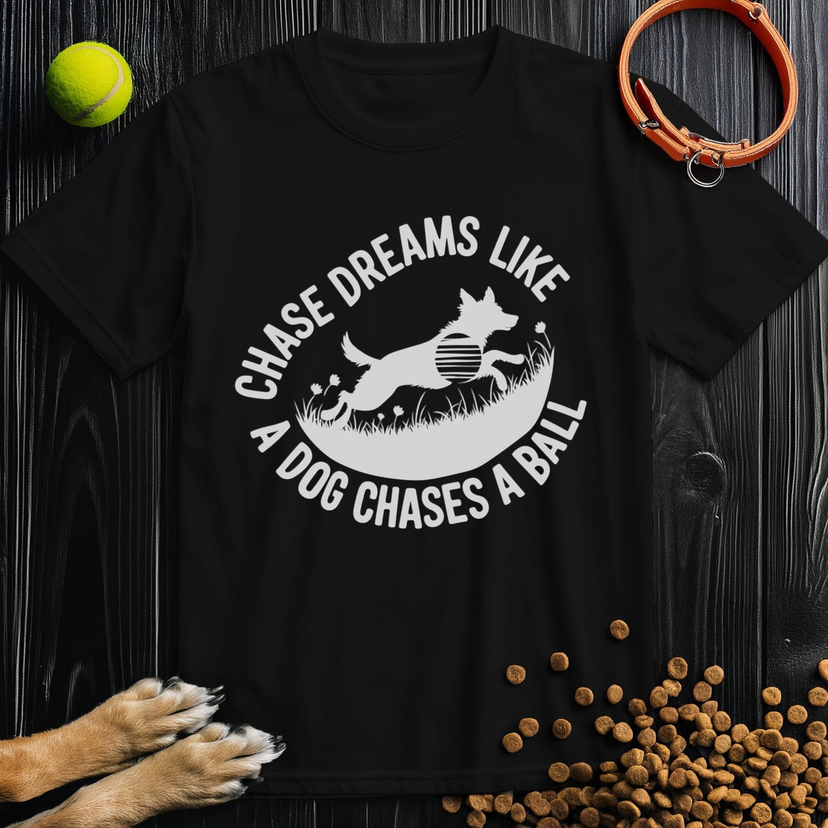 Black Chase Dreams T-Shirt featuring a playful dog graphic and motivational quote. Made from eco-friendly cotton, ideal for casual wear.