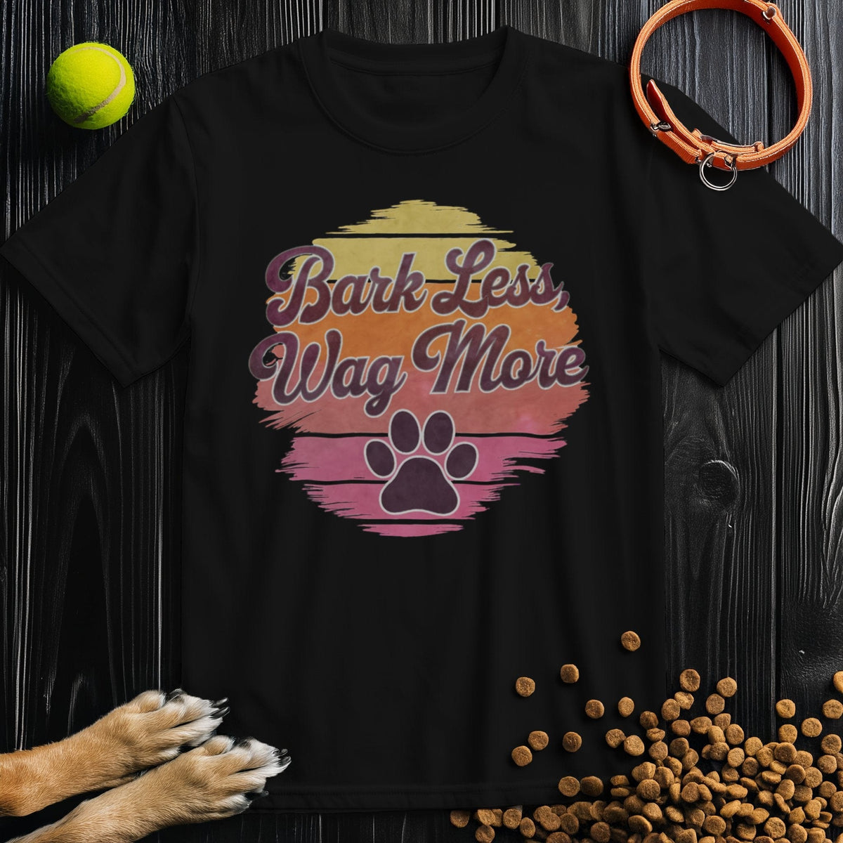 Black Bark Less, Wag More T-Shirt with vintage sunset and paw print. Comfortable cotton tee for dog lovers, regular fit unisex.