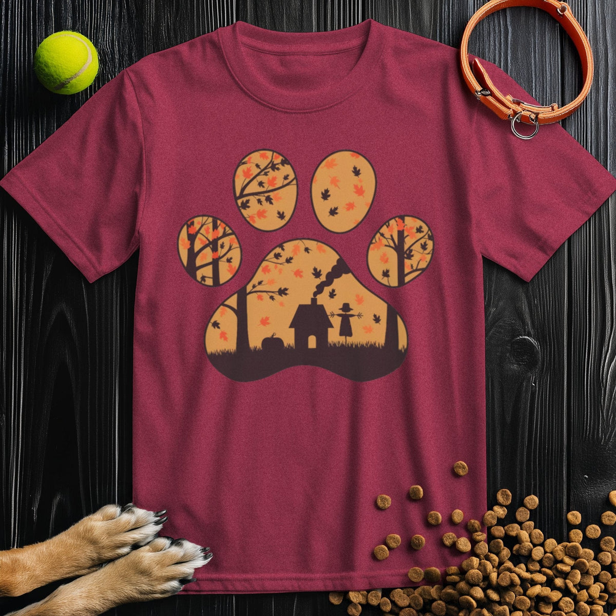 Maroon dog themed T-shirt with a scenic paw print design showing trees and a doghouse. Harvest Woods ethically made cotton apparel.
