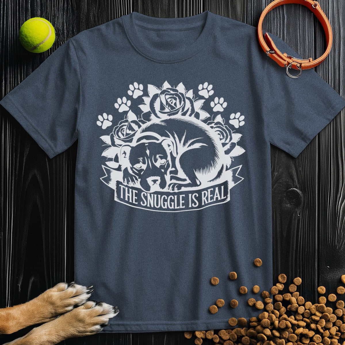 Snuggle Is Real Tee in navy blue featuring a dog curled up with paw prints and roses, made from 100% cotton for dog lovers.