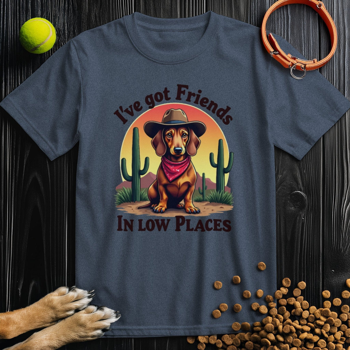 Navy blue 'I've Got Friends In Low Places T-Shirt' for dog lovers featuring a cowboy dachshund graphic, ideal for casual summer wear.