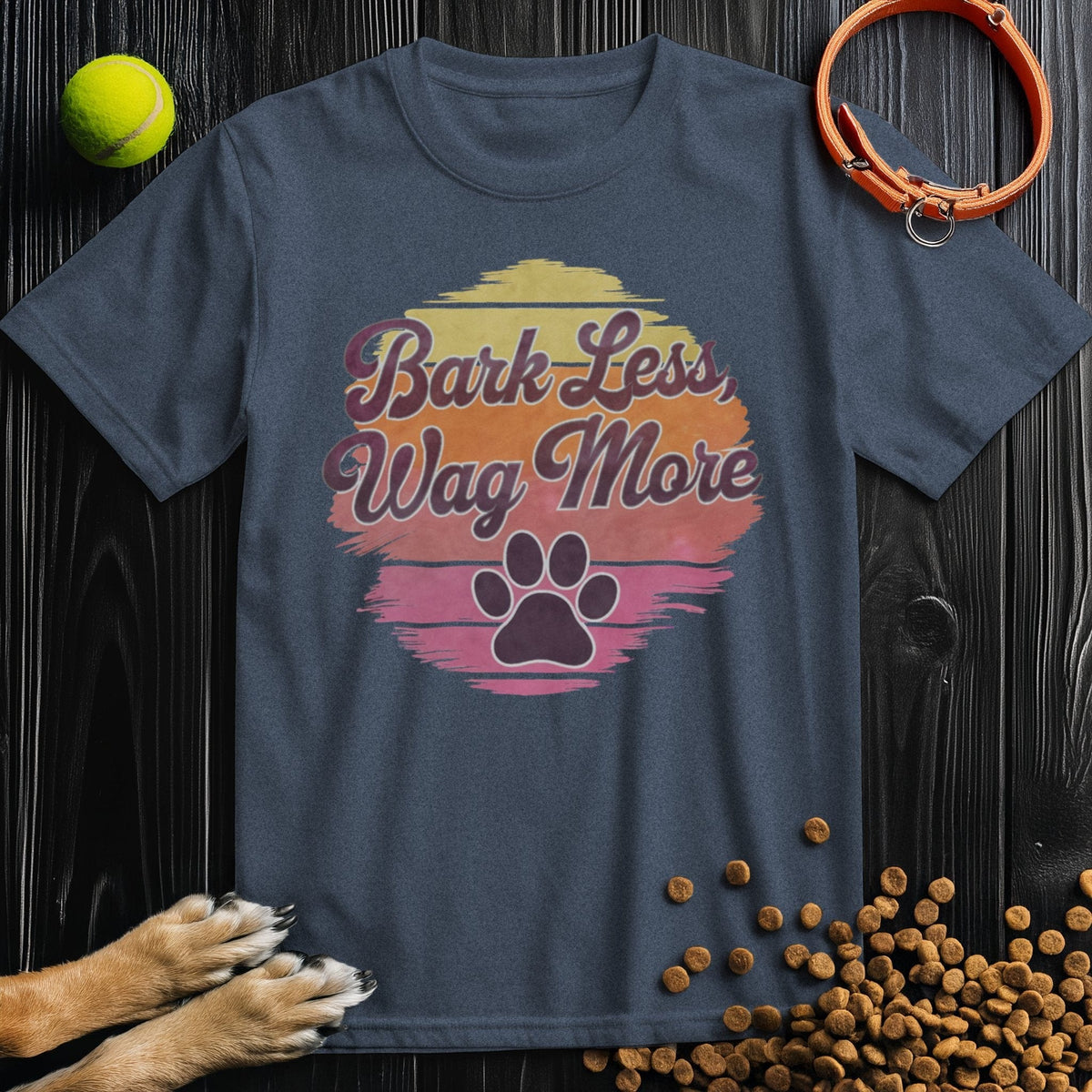 Navy Bark Less, Wag More T-Shirt with retro sunset and paw print graphic. Soft cotton tee ideal for dog enthusiasts, unisex style.