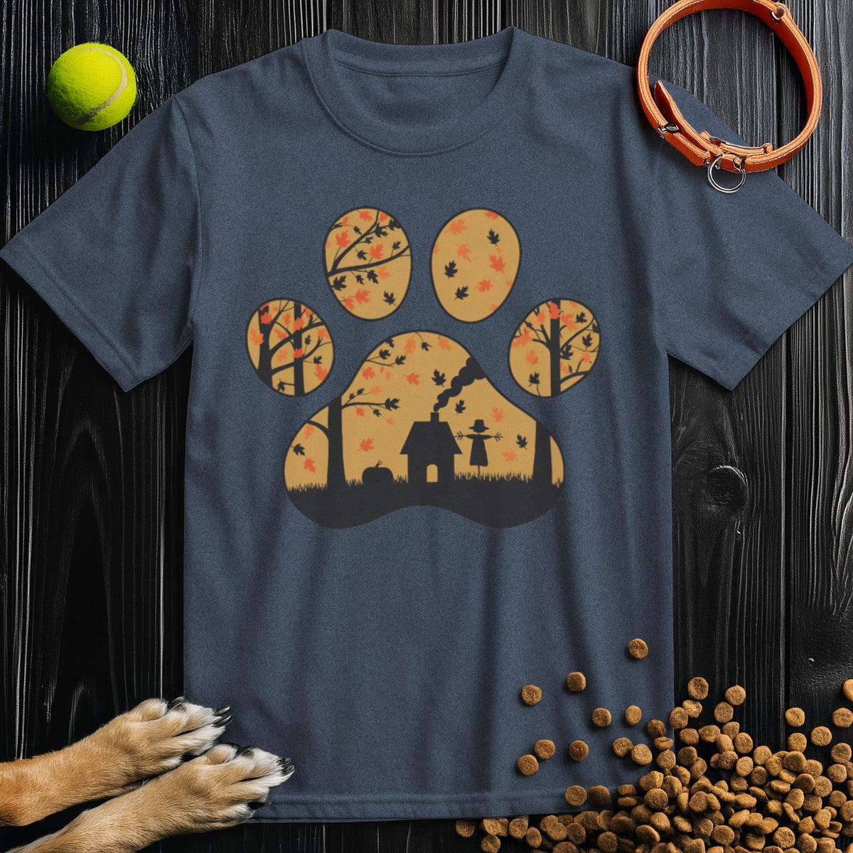 Navy blue Paw Print Dog T-Shirt by Harvest Woods with autumn leaves and doghouse inside a paw print. Stylish dog themed shirt for pet lovers.