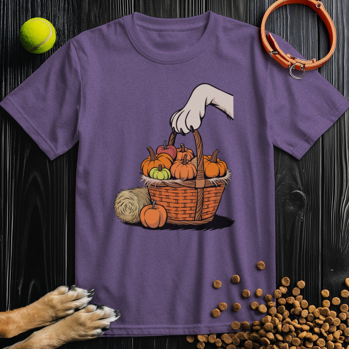 Purple T-shirt for dog lovers featuring a cute paw picking pumpkins. Soft 100% cotton tee perfect for autumn and pet fans.