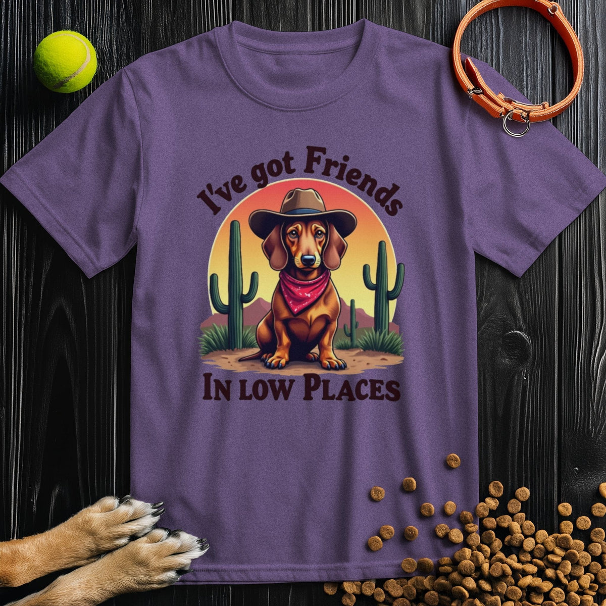 Purple 'I've Got Friends In Low Places T-Shirt' showcasing a western-themed dachshund design, ideal for dog lovers and casual fashion.
