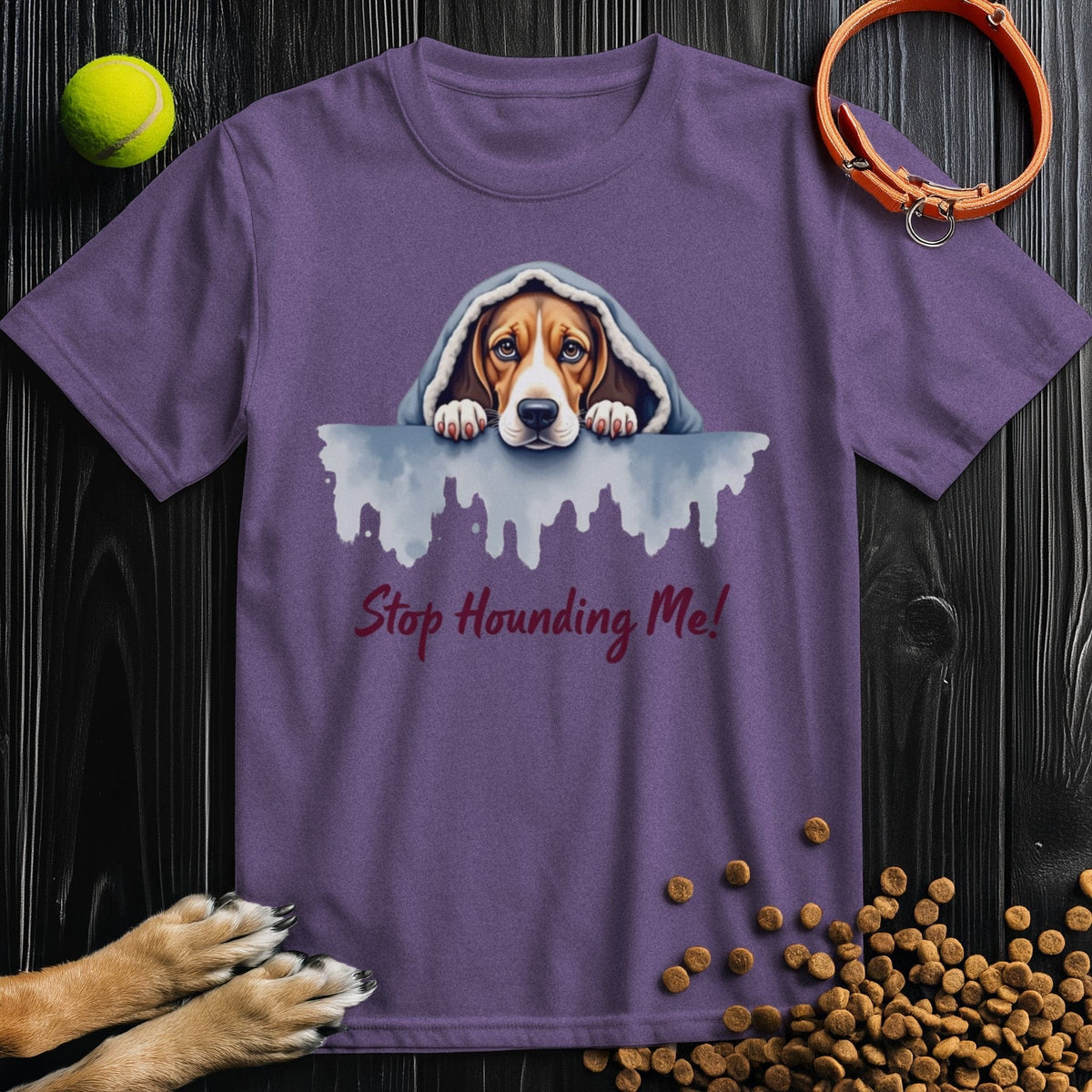 Purple Stop Hounding Me T-Shirt showcasing a watercolor dog under a blanket. Fun cotton tee for dog enthusiasts.