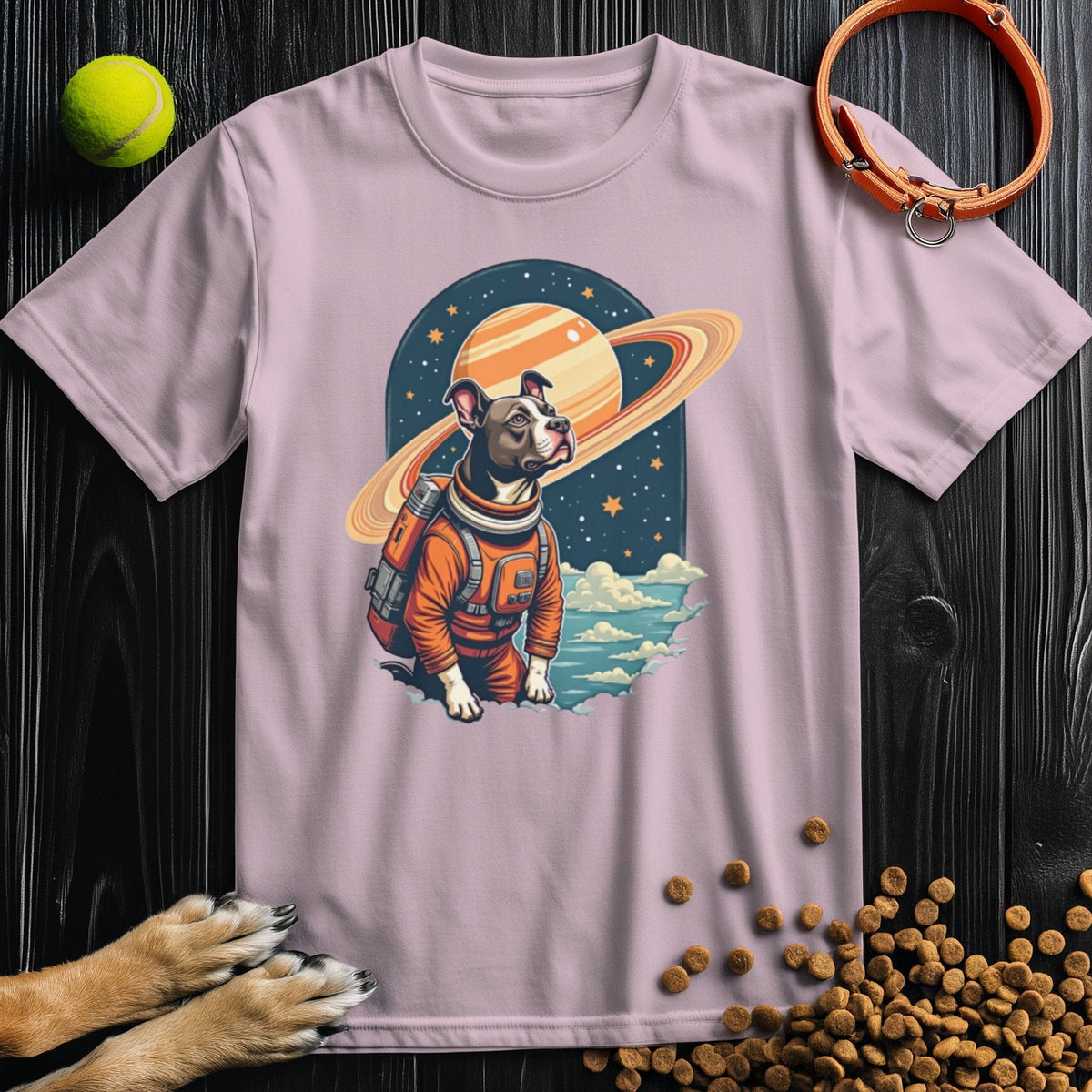 Pink Cosmic Canine T-Shirt with a dog in astronaut gear and Saturn. A playful, stylish choice for dog lovers and casual wear.