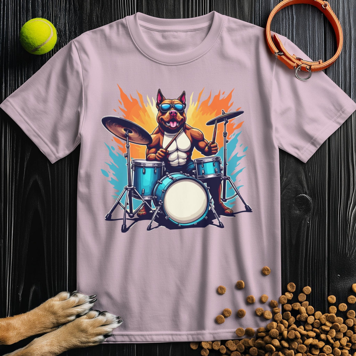 Light pink Premium Drum Dog T-Shirt featuring a playful dog drummer design. Soft cotton fabric ensures comfort and standout style.