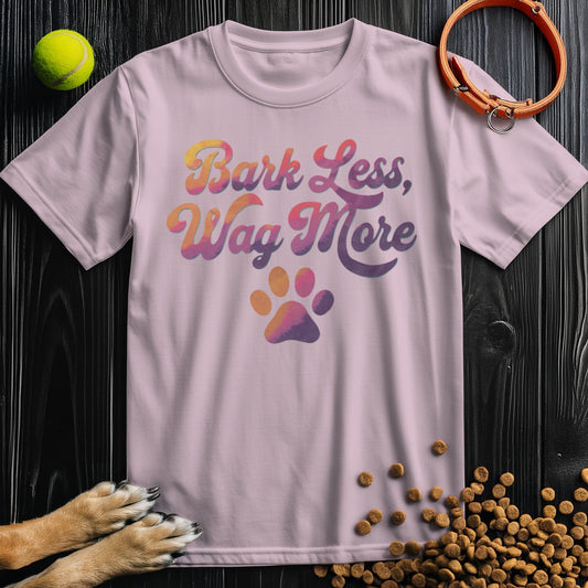 Dog Lover Shirt - Bark Less, Wag More in pastel pink, 100% cotton unisex T-shirt with paw print graphic, perfect for pet enthusiasts.