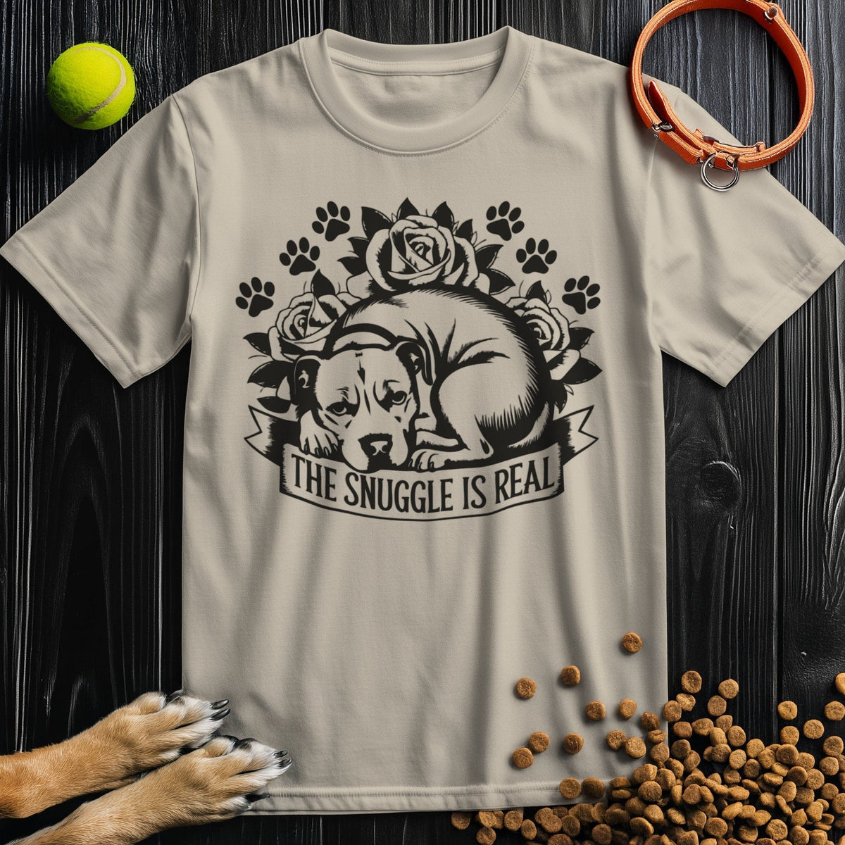 Snuggle Is Real Black T-Shirt in beige featuring a dog curled up with floral and paw print design, made from 100% cotton for pet lovers.