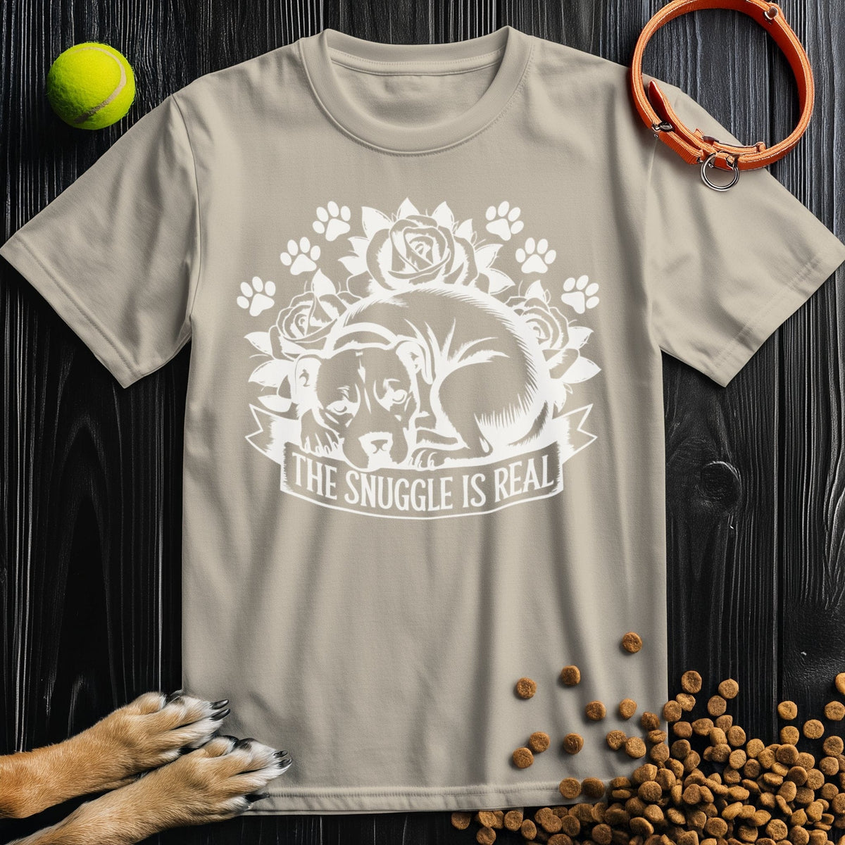 Beige Snuggle Is Real T-shirt with dog and rose print, 100% ring-spun cotton, perfect for pet lovers seeking cozy style.