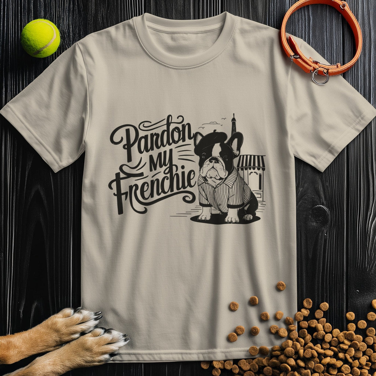 Beige 'Pardon My Frenchie' t-shirt featuring a cute French Bulldog in Parisian attire. Funny Frenchie tee for dog lovers at Good Boy Mob.