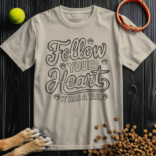 Beige 'Follow Your Heart It Has A Tail' dog t-shirt with paw print design, perfect for pet lovers. Classic crew neck made from soft cotton.